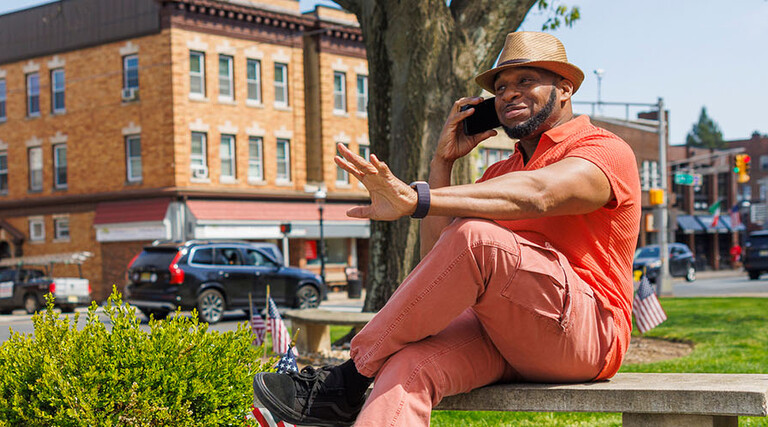 Person talking on the phone in a small town