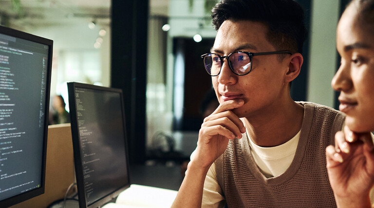 Computer programmers working on code