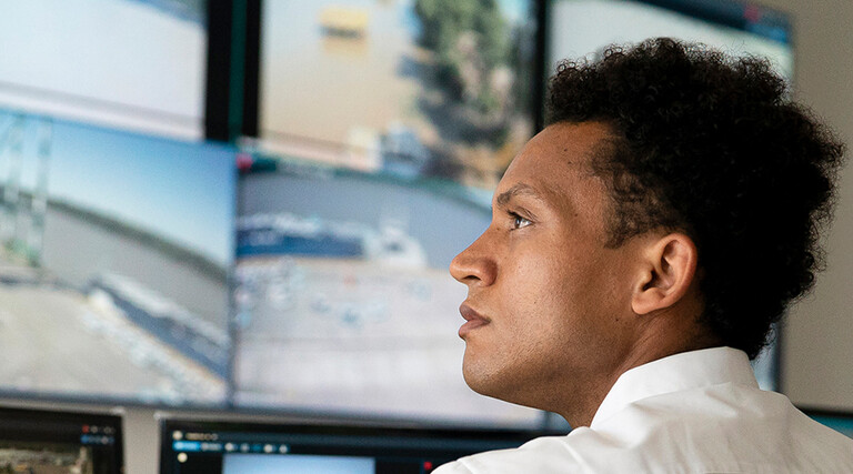 Security worker watching video wall