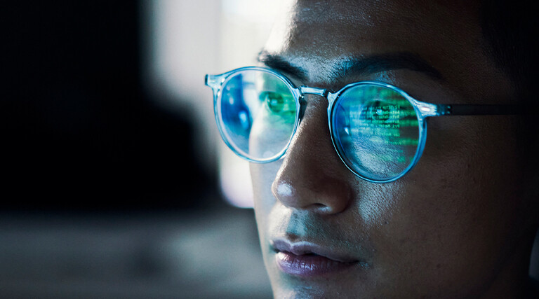 Code reflected in coder's glasses
