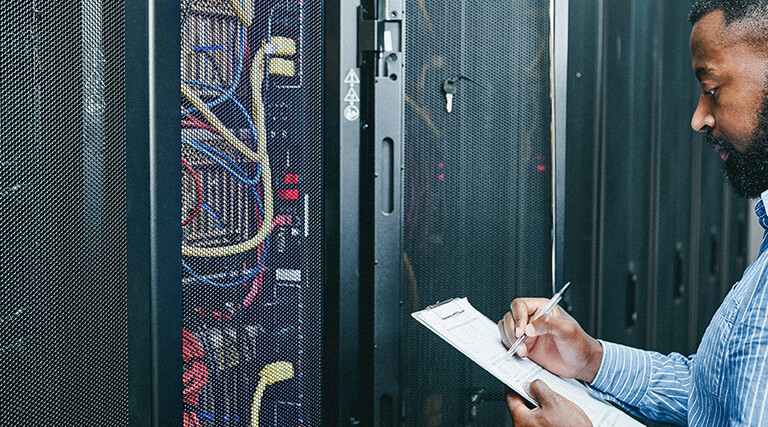 man managing a server room