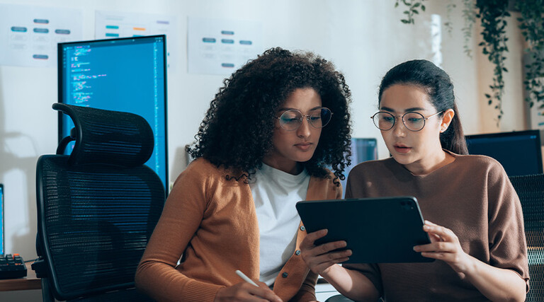 Coworkers viewing tablet