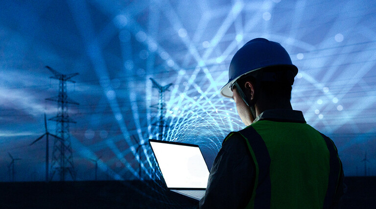 workman with laptop and data lights in the sky