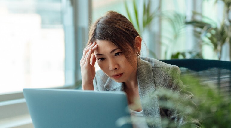 Frustrated person using computer