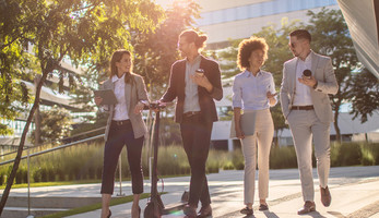 Group of business people waking outside office building