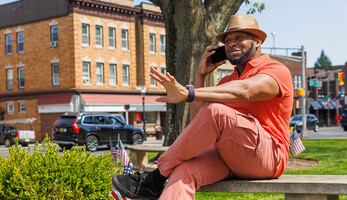 Person talking on the phone in a small town