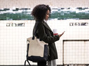 Young woman waiting for the subway train in New York, USA.