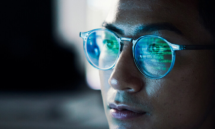 Code reflected in coder's glasses