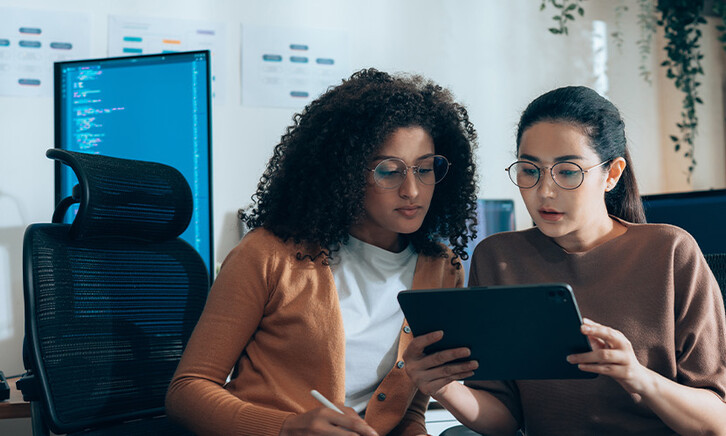 Coworkers viewing tablet