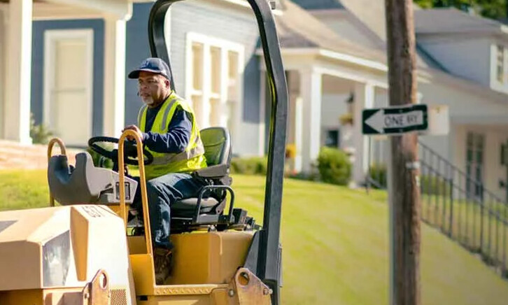 Person patching potholes