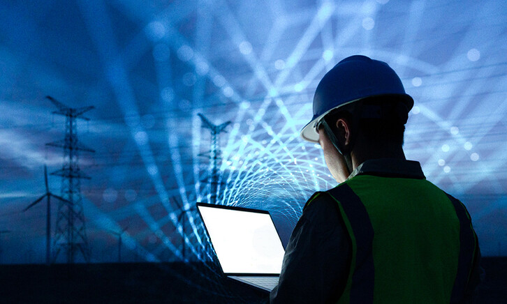 workman with laptop and data lights in the sky