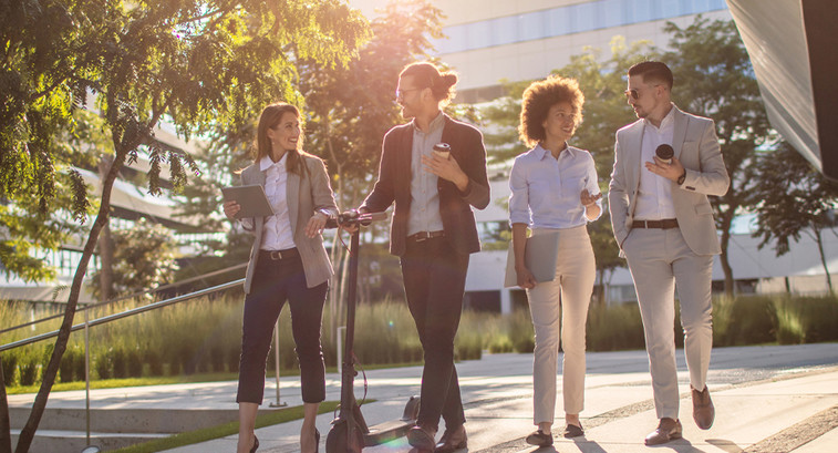 Group of business people waking outside office building