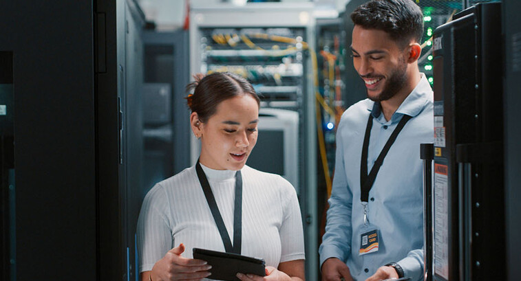 Colleagues working together in a server room