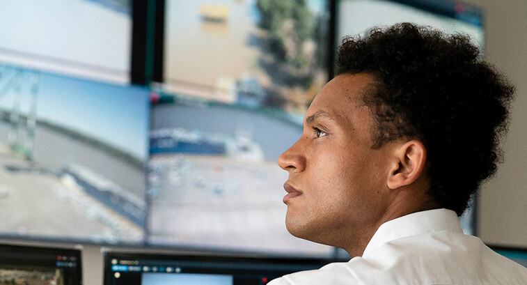 Security worker watching video wall