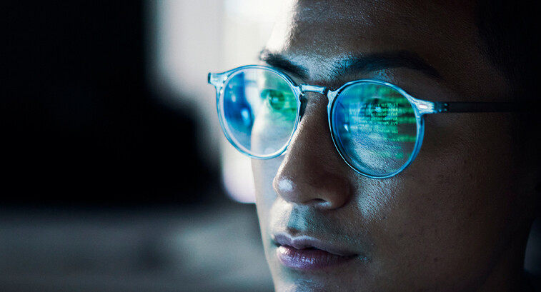 Code reflected in coder's glasses