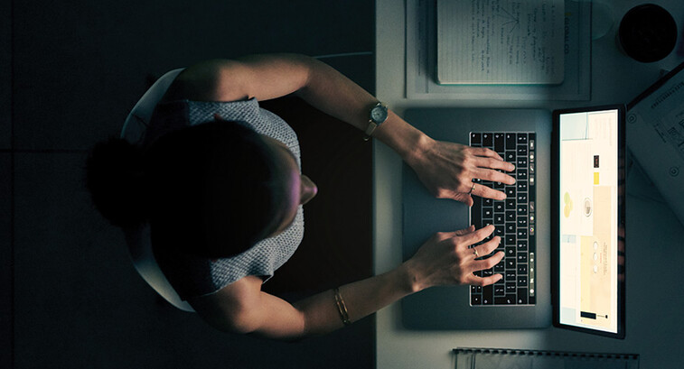 Employee using computer in a dark room