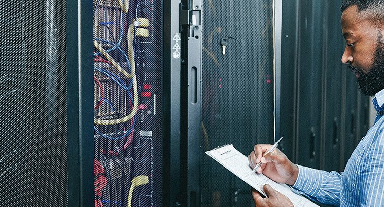 man managing a server room