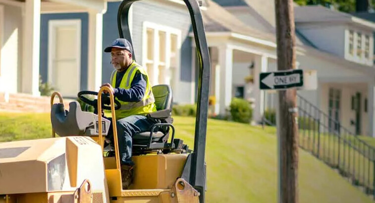 Person patching potholes
