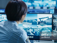 In the Security Control Room Officer Monitors Multiple Screens for Suspicious Activities.