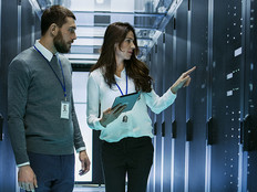 Image of two IT professionals working in a data center.