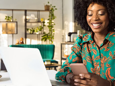 Person using computer and phone