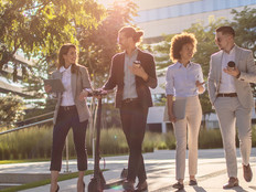 Group of business people waking outside office building