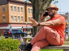 Person talking on the phone in a small town