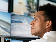 Security worker watching video wall