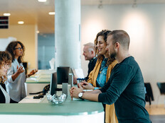People speaking to receptionist
