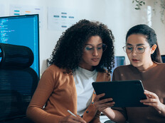 Coworkers viewing tablet