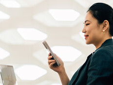 Woman on laptop with phone