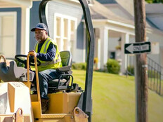 Person patching potholes