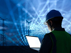 workman with laptop and data lights in the sky