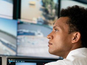 Security worker watching video wall