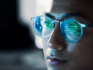 Code reflected in coder's glasses