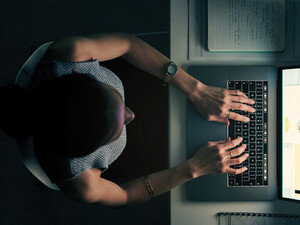 Employee using computer in a dark room