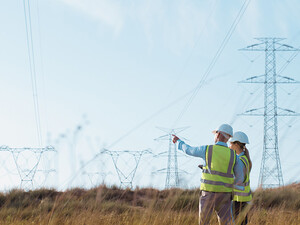 Utility workers examining power lines