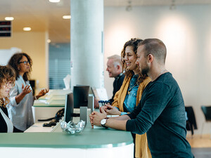 People speaking to receptionist