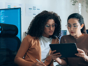 Coworkers viewing tablet