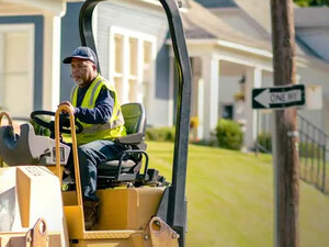 Person patching potholes