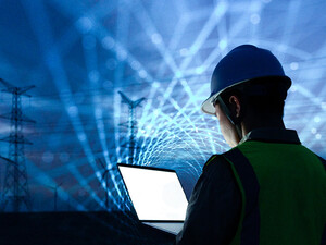 workman with laptop and data lights in the sky
