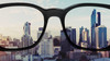 Eye glasses looking to city view, focused on glasses lens