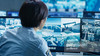 In the Security Control Room Officer Monitors Multiple Screens for Suspicious Activities.