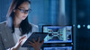 Young Female Government Employee Wearing Glasses Uses Tablet in System Control Center. 