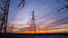 The silhouette of the evening electricity transmission pylon