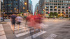 People walking across a cross-walk in Chicago at dusk 