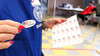 Woman handing out an I voted sticker on Election Day 