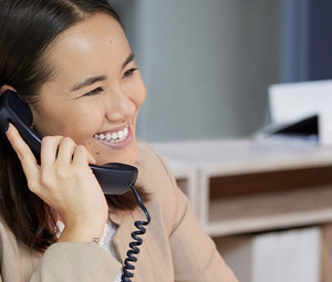 Person talking on the phone at computer