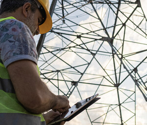 Person using tablet to assess power grid
